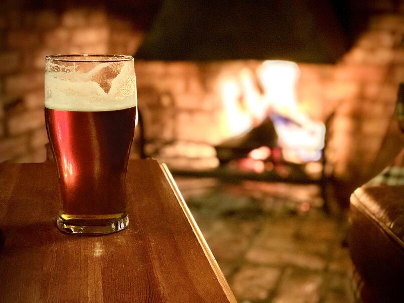 Beer with a cozy fire in the background