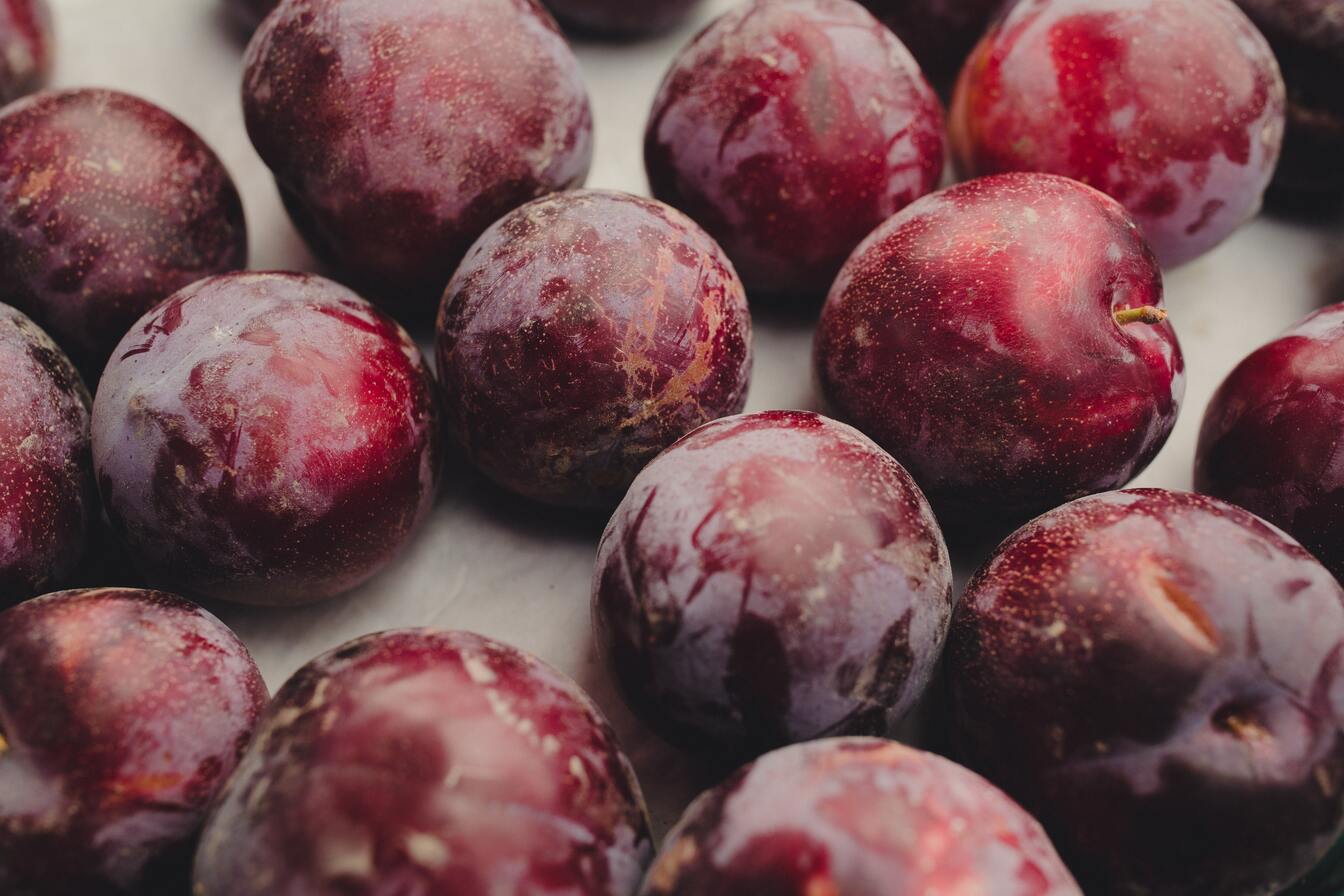 ripe plums on table surface