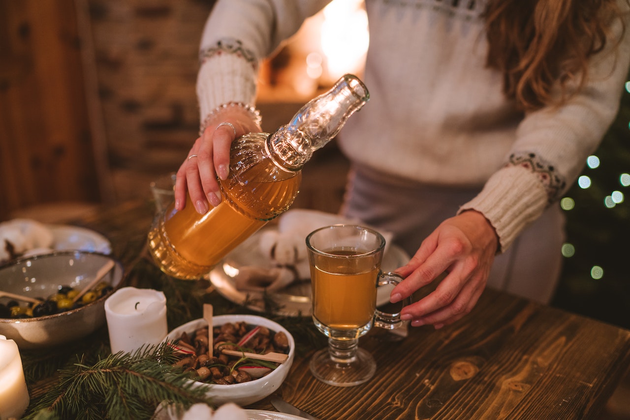 woman serving Christmas fruit beer