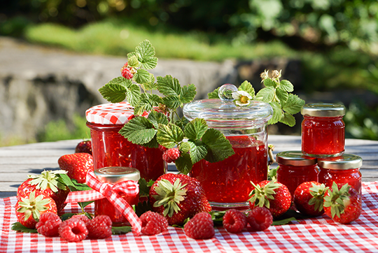 Strawberries and jarred strawberry jam