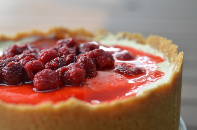 A cheesecake with a raspberry topping